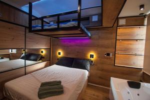 a bedroom with a bed and a sink and a loft at SnowGranada Love Snow Jacuzzi in Sierra Nevada