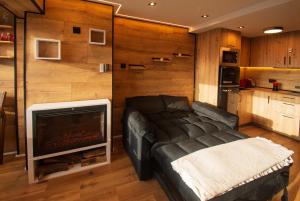 a living room with a couch and a fireplace at SnowGranada Love Snow Jacuzzi in Sierra Nevada