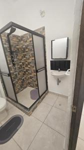 a bathroom with a shower and a sink at Casa La Eliana in Salento