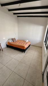a bedroom with a bed in the corner of a room at Casa La Eliana in Salento