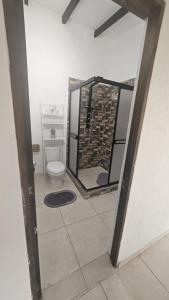 a bathroom with a toilet and a mirror at Casa La Eliana in Salento