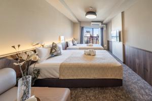 Ένα ή περισσότερα κρεβάτια σε δωμάτιο στο Apartment Hotel 11 Tsutenkaku