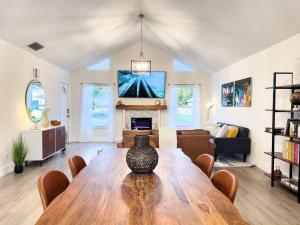 un soggiorno con tavolo in legno e vaso sopra di Costa Bella House a Port Saint Lucie