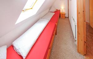 a red bench in a room with a window at Ferienwohnung Südmüritz in Vipperow +13 photos