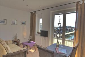a living room with a table and a living room with a view at Ferienwohnung Kutterfisch direkt im Stadthafen in Sassnitz