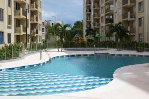 a swimming pool in front of some apartment buildings at El descanso que mereces,es aquí. in Girardot