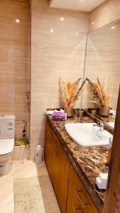 a bathroom with a sink and a toilet at Appartement pied sur mer- resid férmé- pscine in Tamaris