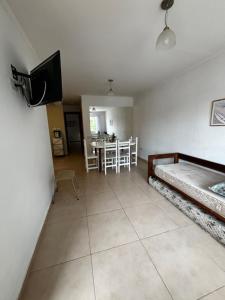 a bedroom with a bed and a tv in a room at Departamento en planta baja in Necochea