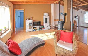 a living room with a couch and a television at Knueppelhof 1 in Silz