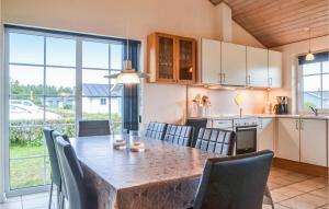 a kitchen and dining room with a table and chairs at Apartment Lønne Feriepark , Seawest M-941 in Lønne Hede
