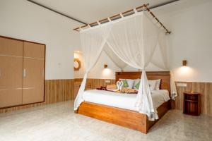 a bedroom with a bed with a canopy at Villa Ole in Ubud +116 photos