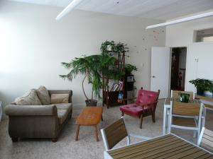a living room with a couch and chairs at Auberge La Petite École de Forillon in Gaspé +12 photos