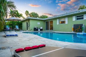 a swimming pool in front of a house at Htd Saltwater Pool! Walk To Beach! Pingpong! Bbq! in West Palm Beach