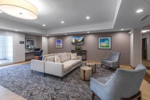 a living room with a couch and two chairs at Candlewood Suites Greenville by IHG in Greenville