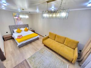 a living room with a bed and a couch at Apartments on Baitursynova 2 in Almaty