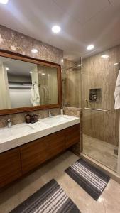 a bathroom with a sink and a shower with a mirror at Comfort at Club De Golf el Tigre in Nuevo Vallarta 