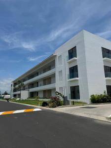 a large white building on the side of a street at Comfort at Club De Golf el Tigre in Nuevo Vallarta 