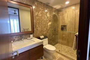 a bathroom with a toilet and a sink and a shower at Comfort at Club De Golf el Tigre in Nuevo Vallarta  +16 photos