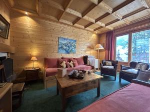 a living room with a couch and a table at Charmant 3 pièces Méribel avec cheminée et proche pistes - FR-1-180-641 in Les Allues
