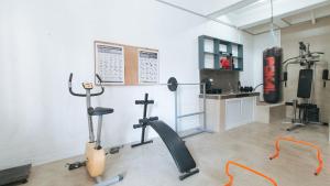 a gym with two exercise bikes in a room at RedDoorz Plus near Tambo Paranaque in Manila