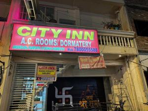 a store sign for a city firm with a sign for a store at Super Hotel O City Inn in Ayodhya +11 photos