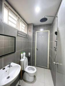 a bathroom with a toilet and a sink and a shower at CozyHouse 4ROOM 3BATH ROOM 10PAX```SimpangAmpatTasek in Simpang Ampat