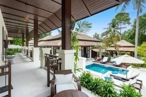 an outdoor patio of a villa with a swimming pool at Renovated Luxury 3 Bed Pool Villa Kirikayan Maenam Koh Samui in Amphoe Koh Samui