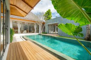 a swimming pool in the backyard of a house at Modern 3BR Pool Villa at Anchan Flora in Bangtao in Bang Tao Beach