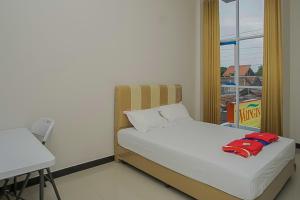 Ένα ή περισσότερα κρεβάτια σε δωμάτιο στο Waringin Guest House Tegal Mitra RedDoorz