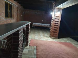 a room with a bench and a brick wall at Vila SCARLET Pielesti Dolj in Cîmpeni +6 photos