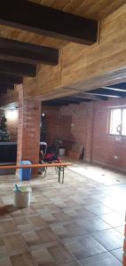 an empty room with a wooden ceiling and a table at Vila SCARLET Pielesti Dolj in Cîmpeni