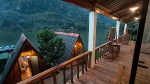 a balcony of a house with a view of a lake at Pont Inn Nong Khiaw in Nongkhiaw