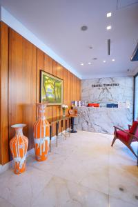 two large orange vases sitting in a room at Hotel Theatro- City Center in Tirana