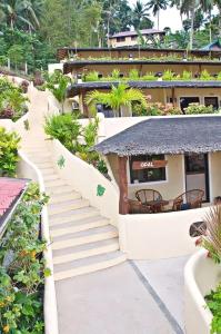 a stairway leading up to a resort building at Oriental Hill Sabang Resort Puerto Galera in Puerto Galera