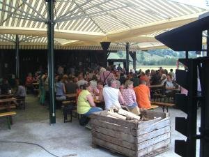 a crowd of people sitting at tables under a tent at Paul-S Apartman in Bad Hofgastein