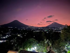 a view of a city and mountains at night at SALU AMAANA Residence Syariah in Wonosobo