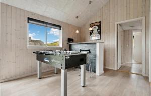 a kitchen with a stove top oven in a room at Awesome Home In Hvide Sande With Sauna in Havrvig