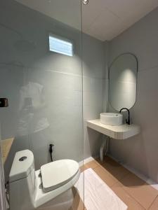 a bathroom with a toilet and a sink and a mirror at Chic house on the beach in Mae Haad