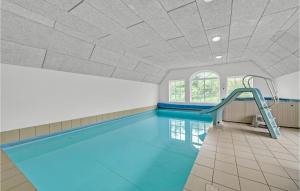 a swimming pool with a slide in the ceiling at Awesome Home In Ulfborg With Kitchen in Ulfborg +23 photos