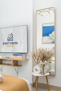 a living room with a mirror and a table at Santorini Studio Pool View in Dubai