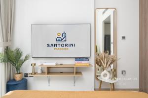 a mirror on a wall in a room with a table at Santorini Studio Pool View in Dubai