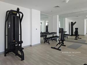 a gym with a row of treadmills and machines at Santorini Studio Pool View in Dubai