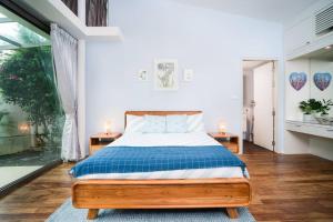 a bedroom with a bed with two night stands and two lamps at Modern Tranquillity Pool Villa, Layan in Laguna Phuket +18 photos
