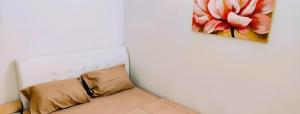 a couch in a room with a painting on the wall at Cozy Homestay in Ipoh