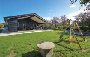 a playground in a yard in front of a house at Four-Bedroom Holiday Home In Haderslev in Haderslev +17 photos
