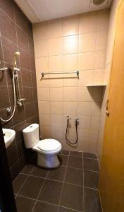 a bathroom with a toilet and a sink at Cozy Homestay in Ipoh