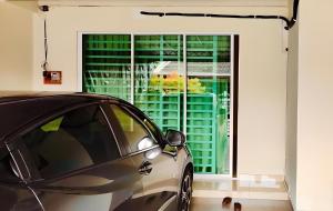 a car parked in front of a large window at Cozy Homestay in Ipoh