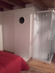a bedroom with a red bed and a window at Cielo Stellato in Vittoria