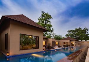 a swimming pool in front of a villa at Bagh Villas I Kanha in Kānha