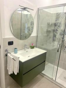 a bathroom with a sink and a shower with a mirror at Casa Grazia in Domodossola +13 photos